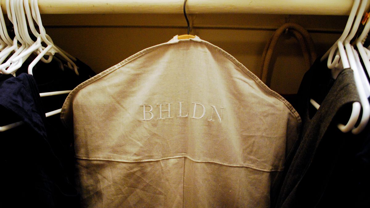 Tan dress cover hanger on a rack saying "BHLDN"