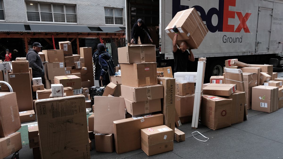 Dozens of packages are lined up along a Manhattan street as a FedEx truck makes deliveries on December 6, 2021 in New York City.