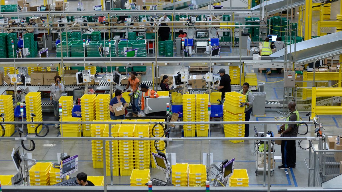 Employees prepare orders at Amazon's San Bernardino Fulfillment Center on October 29, 2013 in San Bernardino, California.
